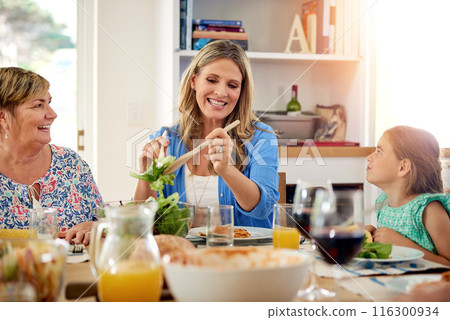 Mother, grandmother and child eating lunch in home for healthy diet, nutrition or wellness of family generations together. Mom, hungry girl or serve food, salad or vegetable to kid with happy grandma Mother, grandmother and child eating lunch in home for healthy diet, nutrition or wellness of family generations together. Mom, hungry girl or serve food, salad or vegetable to kid with happy grandma 116300934