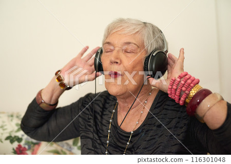 Senior woman, relax and headphones in house with music for retirement, audio playlist and streaming for online radio. Elderly lady, happy and listening to sound in home with excited for hear podcast Senior woman, relax and headphones in house with music for retirement, audio playlist and streaming for online radio. Elderly lady, happy and listening to sound in home with excited for hear podcast 116301048