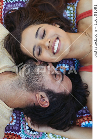 Couple, kiss and happy on blanket, above or relax on ground for picnic, holiday and bonding. Indian people, man and woman with kindness for connection, smile or care on sheet for vacation in Mumbai 116301091