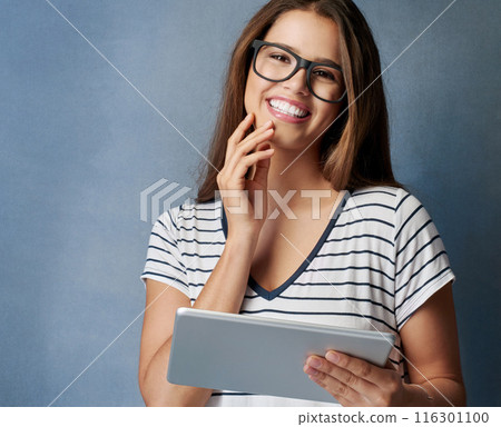 Happy woman, portrait and glasses with tablet for research, social media or online browsing on gray studio background. Female person, employee or young designer with smile on technology for news Happy woman, portrait and glasses with tablet for research, social media or online browsing on gray studio background. Female person, employee or young designer with smile on technology for news 116301100