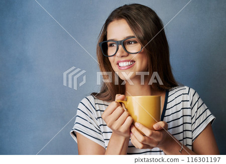 Woman, student and coffee in studio with thinking, drink and glasses on blue background. Break, caffeine and energy or relax for learner person, hands and matcha or green tea for hydration and smile 116301197