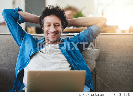 Stretching, relax and happy man on laptop in home living room, wellness or smile with reading email online. Peace of mind, computer or person on sofa for calm, zen or freelancer on social media break 116301198
