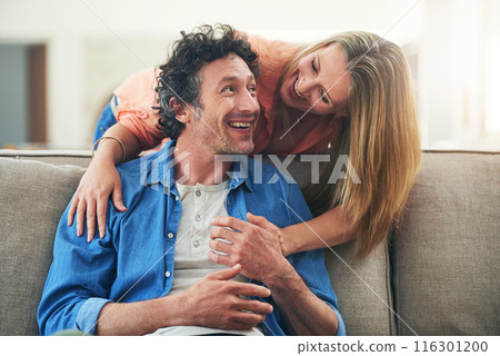 Happy couple, couch and hug in home with love, marriage and romance for man and woman in living room. Sofa, smile or support or solidarity for relationship, relax or trust for commitment and embrace 116301200