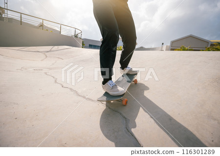 Skateboarder skateboarding at skatepark in city 116301289