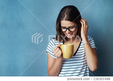 Woman, student and coffee in studio, drink and shy with glasses on blue background. Mockup, caffeine or energy or health for learner person, hands and matcha or green tea for morning latte and relax 116301486