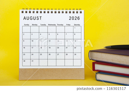August 2026 calendar with yellow cover background and books. New month and calendar concept August 2026 calendar with yellow cover background and books. New month and calendar concept 116301517