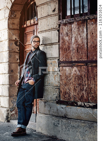 Man, downtown fashion and thinking in city by wall with creative job style and entrepreneur with glasses. Worker, idea and road with trendy, cool and hip clothes in New York outdoor with urban beanie 116301614