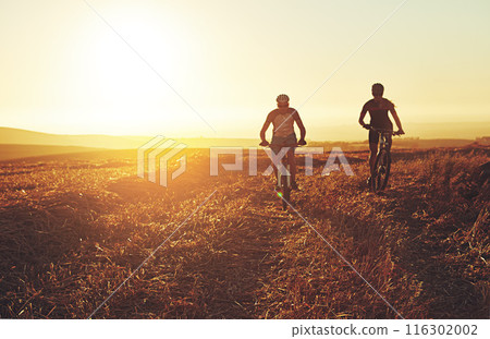 Sunset, people and team on bicycle in countryside with grass, exercise or adventure trail in nature together. Cycling, fitness and friends on mountain bike for evening outdoor workout, sun and mockup Sunset, people and team on bicycle in countryside with grass, exercise or adventure trail in nature together. Cycling, fitness and friends on mountain bike for evening outdoor workout, sun and mockup 116302002