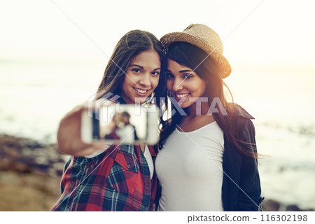Selfie, phone screen and women at beach with fashion holiday, vacation and bonding on weekend. Friends, summer and people with cellphone for photo on social media, online post and profile picture 116302198