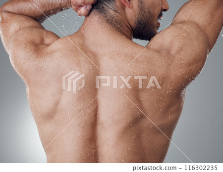 Man, shower and washing back in studio for cleaning, water and skin for grooming on gray background. Male person, cosmetics and liquid for treatment in morning routine, health and hygiene or beauty 116302235