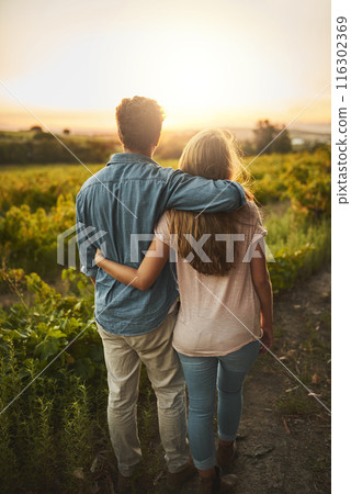 Back, hug and couple in nature, outdoor and together with care, love and date for anniversary in park. Morning, partner and person with embrace, sunrise and peace in field and relax in Texas in farm 116302369