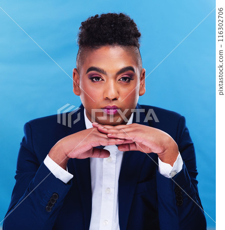 Portrait, man and makeup in studio for fashion, pride or cosmetics on blue background. Gay male person, thinking or sexuality with serious for rouge, lgbt community or transgender identity with style Portrait, man and makeup in studio for fashion, pride or cosmetics on blue background. Gay male person, thinking or sexuality with serious for rouge, lgbt community or transgender identity with style 116302706
