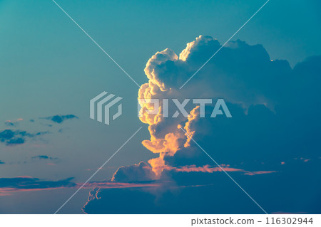 Cumulonimbus clouds rising in the northern sky on a summer evening b-3 Cyan 116302944