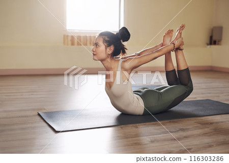 Woman, fitness and stretching for bow in yoga class, wellness and calm exercise for workout or health club or balance. Pilates, holistic and flexibility or body healing, zen and yogi on floor 116303286