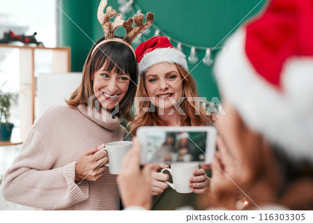 Family, picture and happy for christmas with coffee mug, celebration hug and festive season. Friends, holiday tea time for thanksgiving and cozy for nostalgia, smile for vacation in lounge and love Family, picture and happy for christmas with coffee mug, celebration hug and festive season. Friends, holiday tea time for thanksgiving and cozy for nostalgia, smile for vacation in lounge and love 116303305