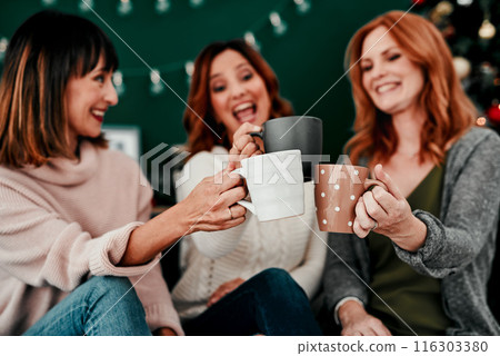 Christmas, women and friends with coffee, cheers or happy in vacation of festive season or group. Home, lounge or people with hot chocolate, warm or smile of girls trip, together or excited for toast 116303380