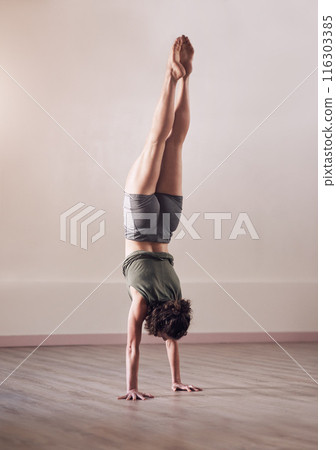 Woman, handstand and yoga exercise in fitness studio of space, body and wellness for health. Back of person, upside down for balance or pilates, agility and strong core for power with flexibility 116303385