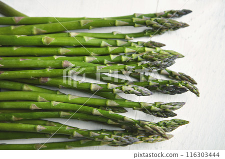 Asparagus, kitchen and food on table for wellness, lunch or decision with nutrition for health. Organic vegetable, cooking and above for benefit on counter, detox or meal prep for vegan diet in home Asparagus, kitchen and food on table for wellness, lunch or decision with nutrition for health. Organic vegetable, cooking and above for benefit on counter, detox or meal prep for vegan diet in home 116303444