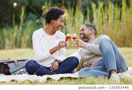 Black couple, wine and picnic at park with cheers for anniversary date, honeymoon celebration and romance with smile. People, relax and happy on grass in nature with support, success and holiday fun Black couple, wine and picnic at park with cheers for anniversary date, honeymoon celebration and romance with smile. People, relax and happy on grass in nature with support, success and holiday fun 116303446