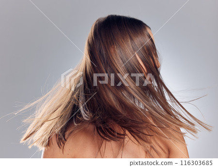 Movement, hair care and woman in studio with growth, keratin treatment and balayage on gray background. Salon, excited and female person with cosmetic shine for style, texture and wellness or beauty 116303685