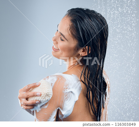 Shower water, hygiene and woman with sponge, glow results and cleaning skin for natural shine in studio. Liquid drops, model girl and soap washing with foam on body and skincare by grey background Shower water, hygiene and woman with sponge, glow results and cleaning skin for natural shine in studio. Liquid drops, model girl and soap washing with foam on body and skincare by grey background 116303849
