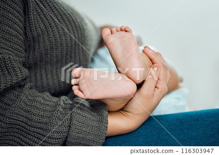 Baby, hands and mother holding feet for growth, support and development in family home. Newborn, woman and wellness in bedroom for relax, security and together with love and care for child and mama 116303947