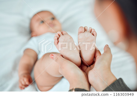 Hands, baby and mother holding feet for growth, support and development in family home. Newborn, woman and wellness in bedroom for relax, security and together with love and care for child and mama Hands, baby and mother holding feet for growth, support and development in family home. Newborn, woman and wellness in bedroom for relax, security and together with love and care for child and mama 116303949