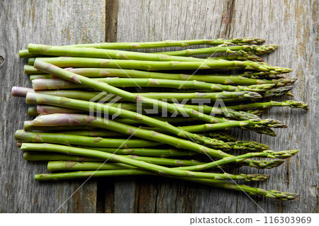 Asparagus, kitchen and diet on table for nutrition, lunch or product with wellness for health. Organic vegetable, cooking and above for benefit on counter, detox or meal prep for vegan food in home Asparagus, kitchen and diet on table for nutrition, lunch or product with wellness for health. Organic vegetable, cooking and above for benefit on counter, detox or meal prep for vegan food in home 116303969