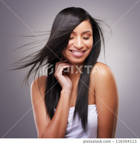 Salon, haircare and happy woman in studio with eyes closed for keratin, shampoo or natural cosmetics on gray background. Beauty, wind and hand of model for satisfaction, growth or collagen shine 116304113