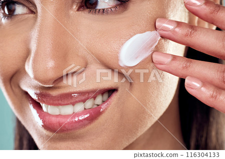Woman, cream and thinking to apply in studio, hydration and cleaning or skincare on blue background. Female person, beauty and plan for facial treatment or cosmetics, pamper routine and sunscreen Woman, cream and thinking to apply in studio, hydration and cleaning or skincare on blue background. Female person, beauty and plan for facial treatment or cosmetics, pamper routine and sunscreen 116304133