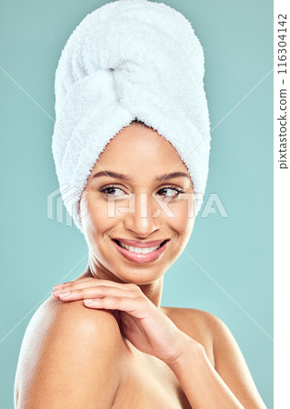 Woman, idea and towel on head in studio for shower, hygiene and smile for cleaning. Model girl, happy and thinking for wellness, grooming and glow in morning with skincare by blue background 116304142