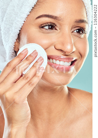 Skincare, toner and woman with cotton for natural shine, makeup removal and dermatology in studio. Beauty, model girl and facial pad with hyaluronic acid for skin glow and moisture by blue background 116304222