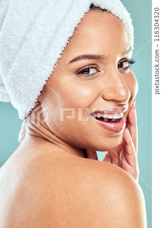 Happy woman, portrait and beauty with towel in studio with healthy, wellness and clean face. Female person, skincare and smile for results, cosmetic or dermatology for glowing skin in blue background Happy woman, portrait and beauty with towel in studio with healthy, wellness and clean face. Female person, skincare and smile for results, cosmetic or dermatology for glowing skin in blue background 116304320