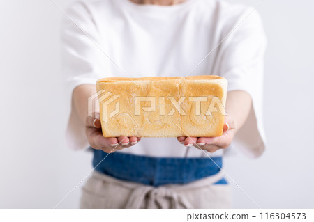 Woman holding bread 116304573