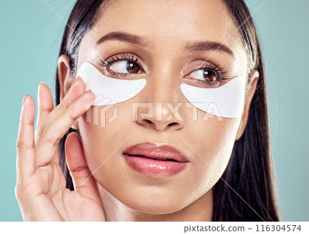Woman, hands and eye patch for beauty and skincare, hydration and refresh on blue background. Closeup, dermatology and facial treatment for collagen, thinking and detox for female person in studio 116304574