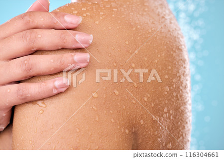 Hand, woman and shower while cleaning shoulder in studio with female, washing and beauty. Water, model and wellness of a young person in bathroom for self care and dermatology by blue background Hand, woman and shower while cleaning shoulder in studio with female, washing and beauty. Water, model and wellness of a young person in bathroom for self care and dermatology by blue background 116304661