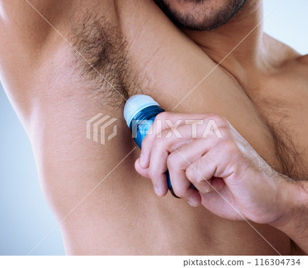Man, armpit and deodorant in studio for wellness, hygiene and fresh for self care with scent. Roll on, skincare and male person by white background for cologne, cosmetics and morning routine Man, armpit and deodorant in studio for wellness, hygiene and fresh for self care with scent. Roll on, skincare and male person by white background for cologne, cosmetics and morning routine 116304734