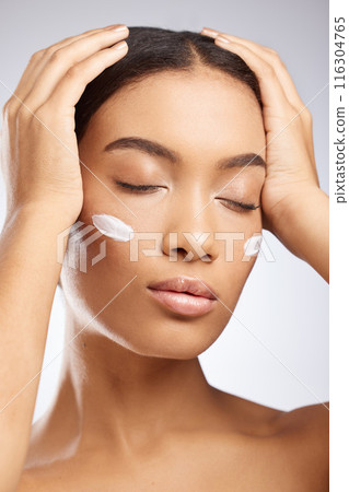 Calm, face and woman with sunscreen for skincare and dermatology in studio background. Model, relax and girl with moisturizer lotion on skin for healthy glow or cream for natural beauty and cosmetics Calm, face and woman with sunscreen for skincare and dermatology in studio background. Model, relax and girl with moisturizer lotion on skin for healthy glow or cream for natural beauty and cosmetics 116304765