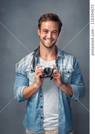 Camera, happy and portrait of man in studio for digital production, media and photoshoot. Smile, photographer and happy with dslr equipment for creative, art and journalist on blue background 116304872