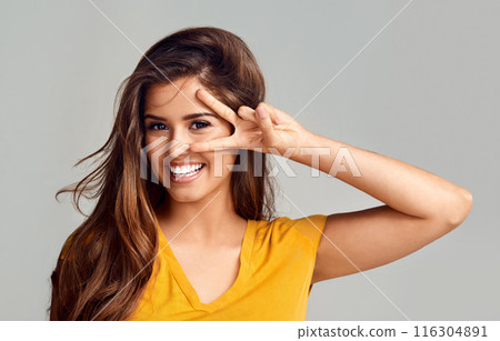 Portrait, smile and woman with peace sign in studio with happiness for freedom, good mood or face expression on white background. V, emoji and female model for hand gesture, positivity or confidence 116304891