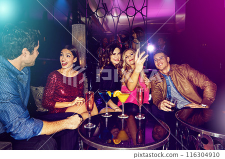 People, selfie or friends in nightclub with cocktails, smile or drinks for memory, vip event or reunion. Pictures, men or happy women on dark party couch for alcohol, photograph or social celebration 116304910