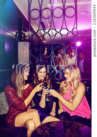 Girls, cheers and friends in nightclub with alcohol, glass or cocktails for bonding, event or reunion. Vip lounge, women and happy people in dark disco party for drinks or social celebration to toast 116304934