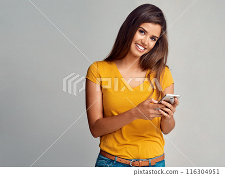 Woman, smile and portrait with smartphone in studio background for social media, networking and online dating. Female person, happy and notification with good news, text message and mockup space 116304951