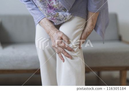 The hands of an 80-year-old woman holding her knee The hands of an 80-year-old woman holding her knee 116305184