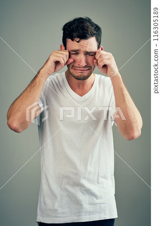 Man, hands and sad or face in studio, upset and disappointed emoji or depression or mental health crisis. Emotional, background and male person with crying expression, overwhelmed anxiety and unhappy 116305189