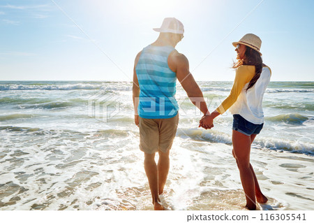 Couple, beach and holding hands with summer, holiday or vacation for love, support and romance in sun. Back of young people walking together and happy for anniversary, date or valentines day in ocean Couple, beach and holding hands with summer, holiday or vacation for love, support and romance in sun. Back of young people walking together and happy for anniversary, date or valentines day in ocean 116305541
