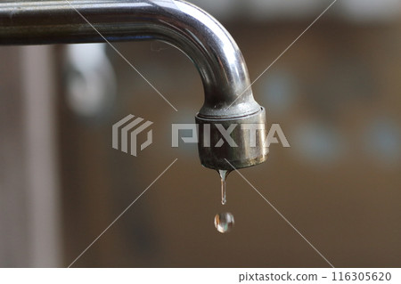 Image of water dripping from a water faucet, water outage or water conservation 116305620