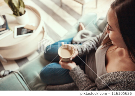 Woman, relax and sofa with coffee above for morning, drink or caffeine in living room at home. Top view of young female person with mug for warm beverage, cappuccino or latte on lounge couch at house 116305626