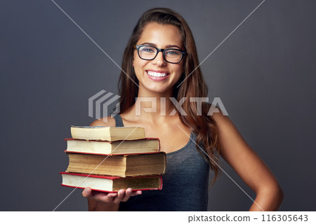 Happy woman, portrait and books in studio for education, learning or study with glasses isolated on gray background. Student, face or textbook stack to research knowledge or information at university Happy woman, portrait and books in studio for education, learning or study with glasses isolated on gray background. Student, face or textbook stack to research knowledge or information at university 116305643