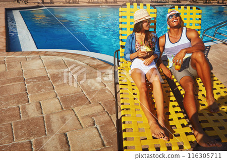 Couple, poolside and alcohol to relax on weekend, outdoor and travel to hotel resort for vacation. People, peace and sunglasses by water for drinks, bonding and love by swimming pool for wellness Couple, poolside and alcohol to relax on weekend, outdoor and travel to hotel resort for vacation. People, peace and sunglasses by water for drinks, bonding and love by swimming pool for wellness 116305711